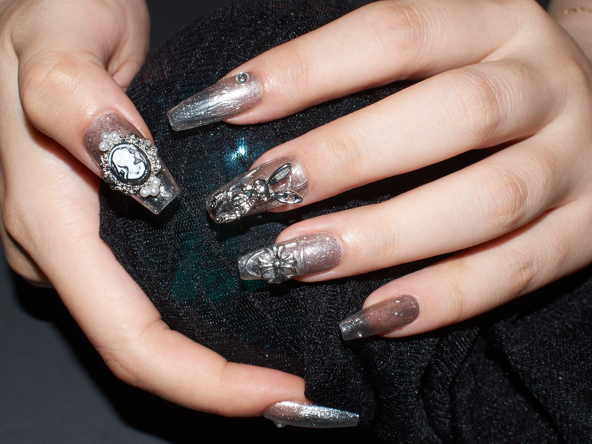 black with nude nails, playboy bunny nail charms, cross nail charms, long press on coffin nails, monoschic