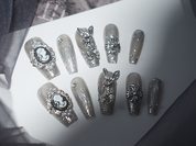 black with nude nails, playboy bunny nail charms, cross nail charms, long press on coffin nails, monoschic