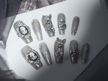 black with nude nails, playboy bunny nail charms, cross nail charms, long press on coffin nails, monoschic