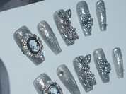 black with nude nails, playboy bunny nail charms, cross nail charms, long press on coffin nails, monoschic