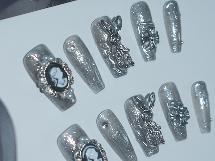 black with nude nails, playboy bunny nail charms, cross nail charms, long press on coffin nails, monoschic