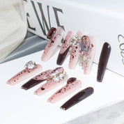 Elegant burgundy blush press-on nails with intricate designs and embellishments, presented on a white background