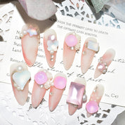 Set of pink candy matte press-on nails with 3D pearl and butterfly accents, displayed on a decorative card.